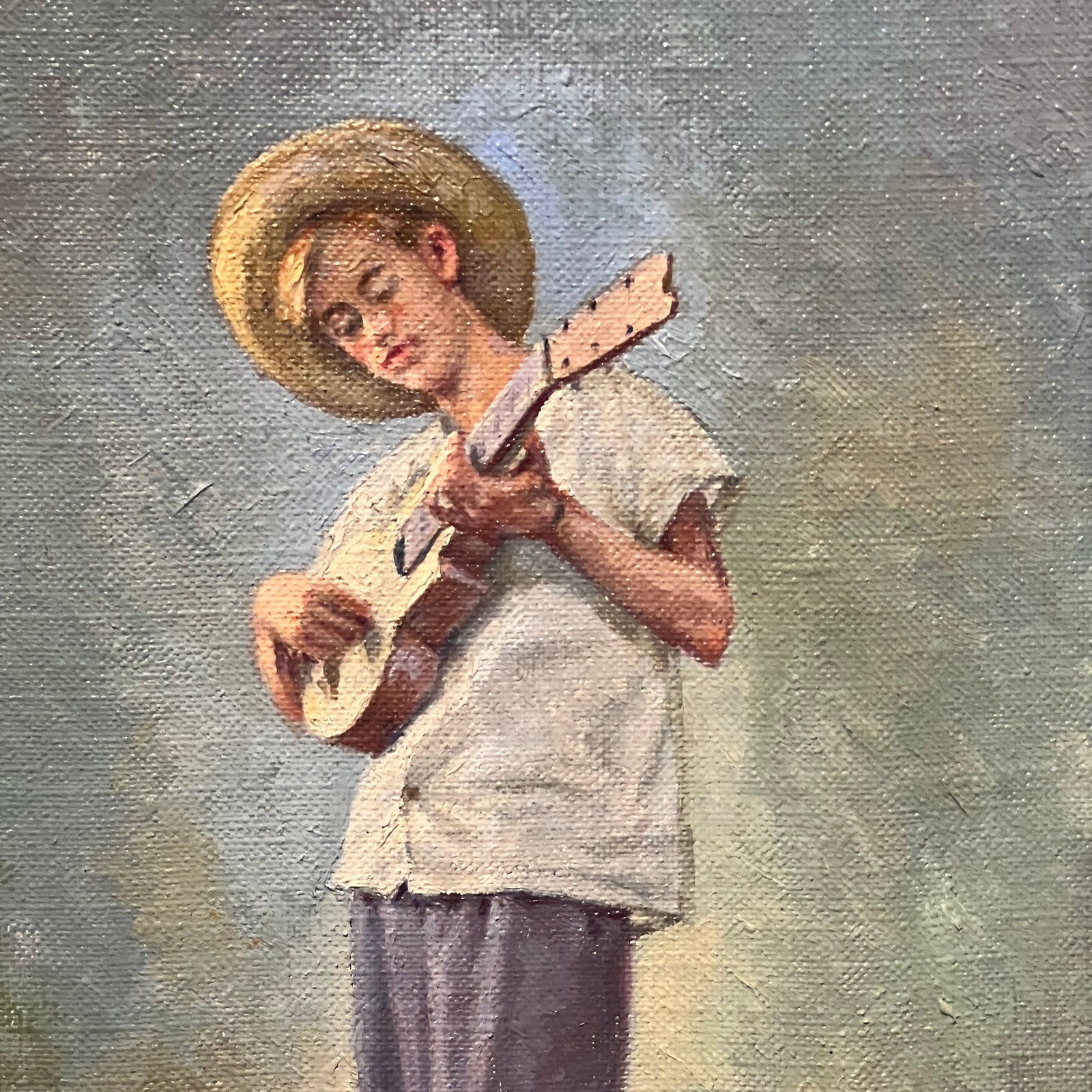 Aerial view of a town square with a prominent blue and white building, likely a church, surrounded by other buildings and greenery.